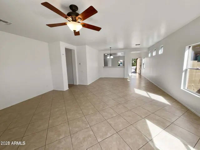 a view of an empty room and a windows fan