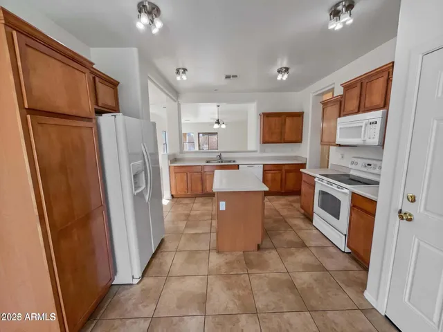 a kitchen with stainless steel appliances a refrigerator and a stove
