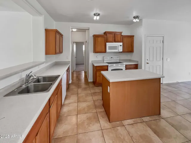 a kitchen with stainless steel appliances a sink and a microwave