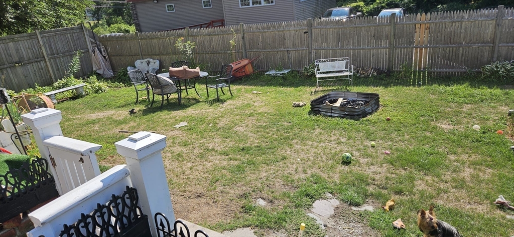 122 Pleasant Valley Street Methuen, MA 01844 - Photo 11 of 27 a backyard of a house with table and chairs