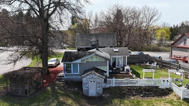 a view of a house with a yard and sitting area