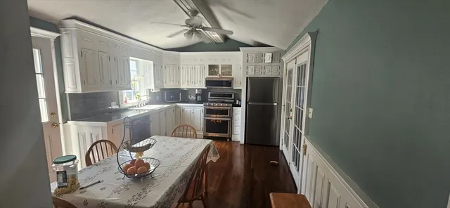 a kitchen with a refrigerator and a stove top oven