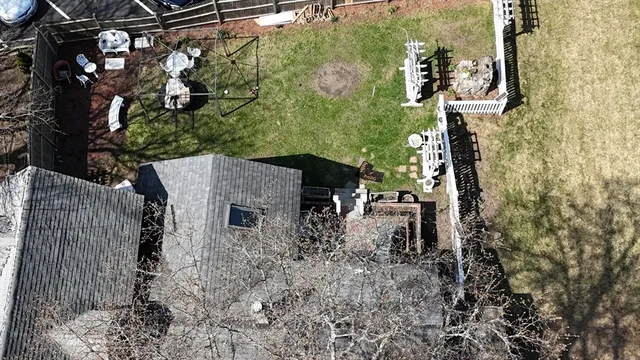 a backyard of a house with lots of green space and glass windows