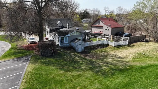 a view of a house with backyard and sitting area