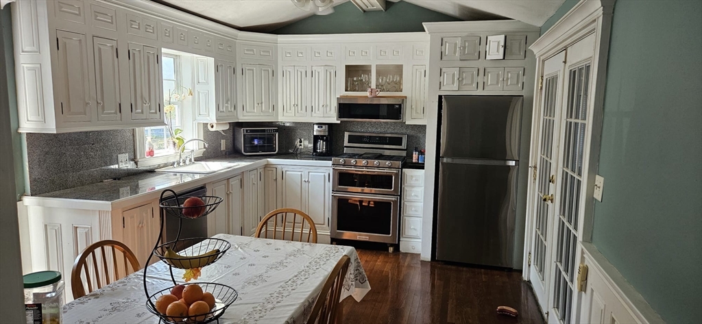 122 Pleasant Valley Street Methuen, MA 01844 - Photo 3 of 27 a kitchen with stainless steel appliances granite countertop a refrigerator a stove a sink and a microwave