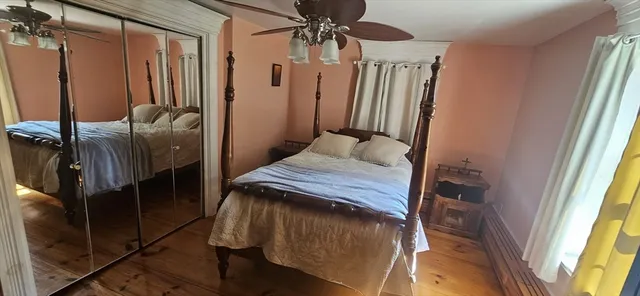a bedroom with a bed closet and a mirror