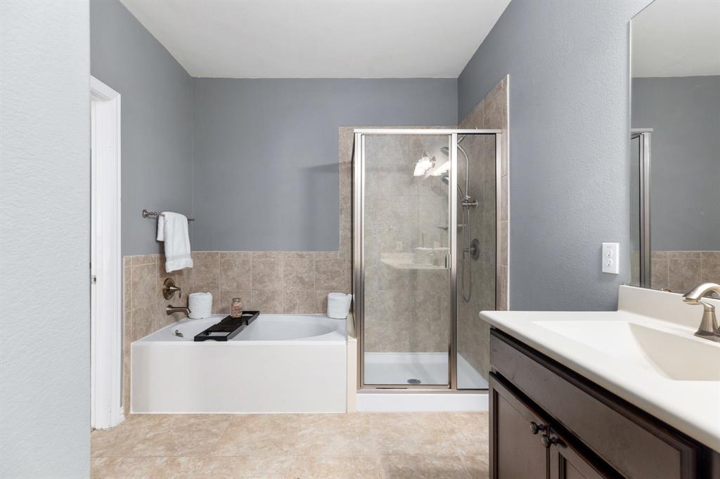 464 Evening Star Kyle, TX 78640 - Photo 5 of 8 Indulge in this bathroom featuring a relaxing soaking tub and a sleek, glass-enclosed shower.