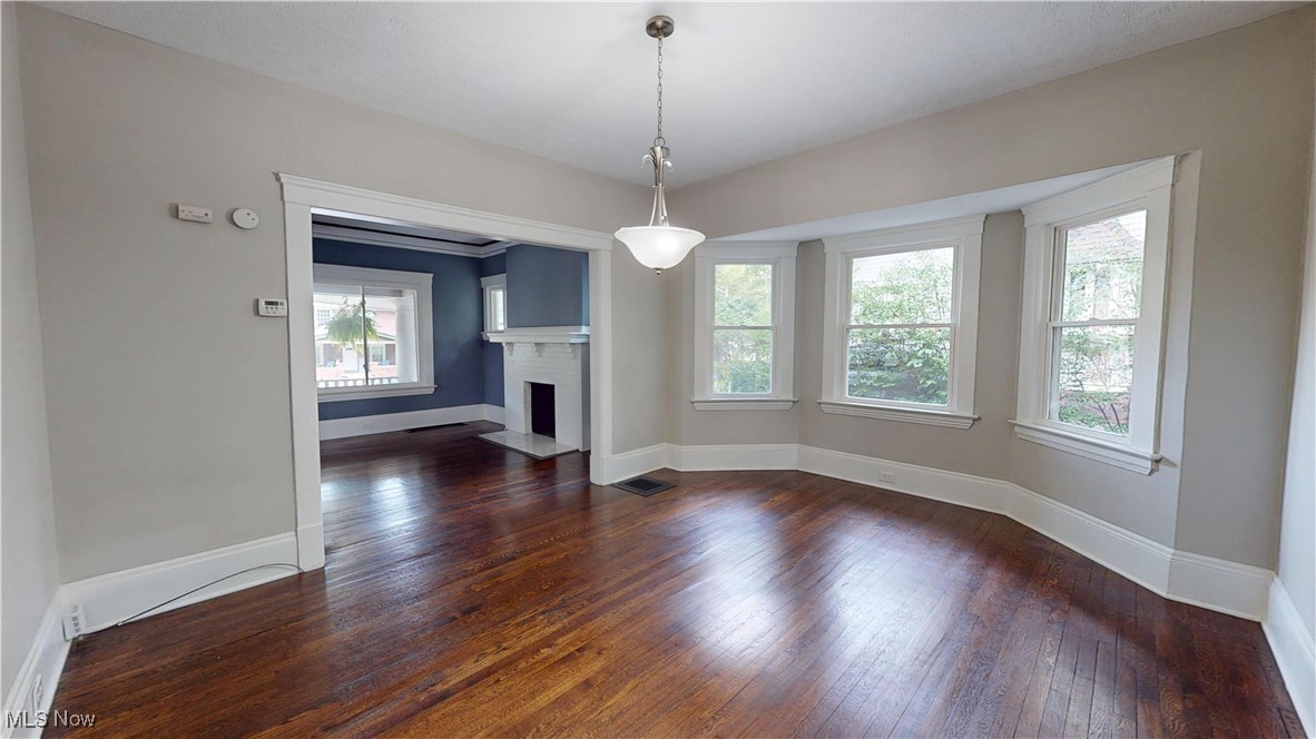 3174 Oak Road Cleveland, OH 44118 - Photo 9 of 33 Unfurnished living room featuring dark wood-type flooring and a fireplace with flush hearth
