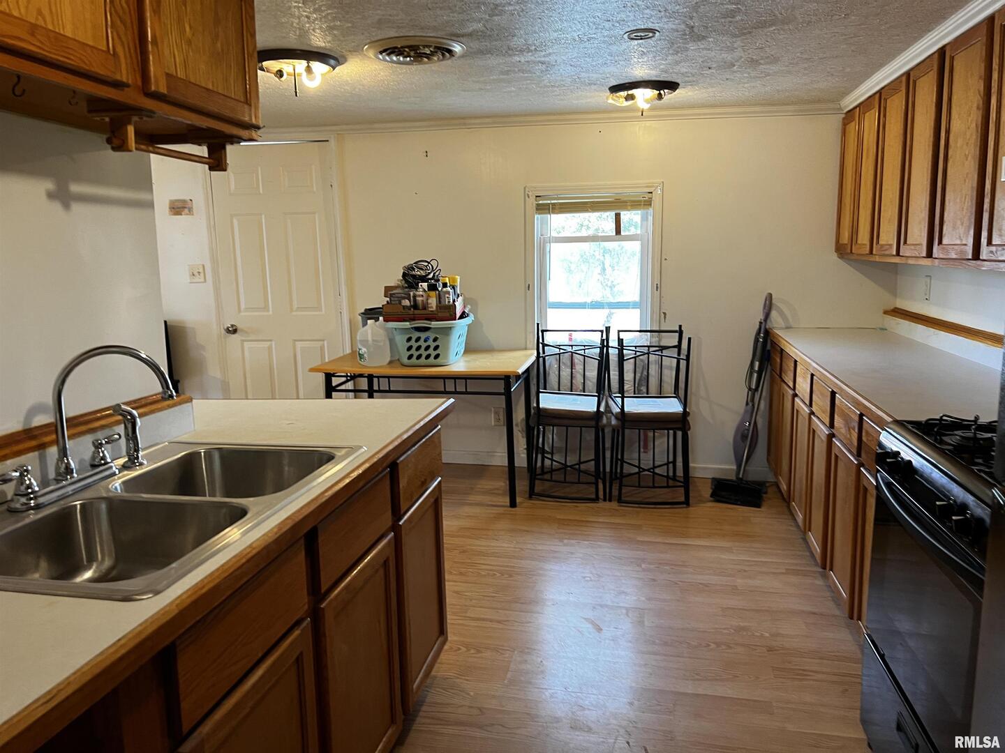 6846 East 1st Street Logan, IL 62856 - Photo 11 of 16 a kitchen with sink cabinets and stove