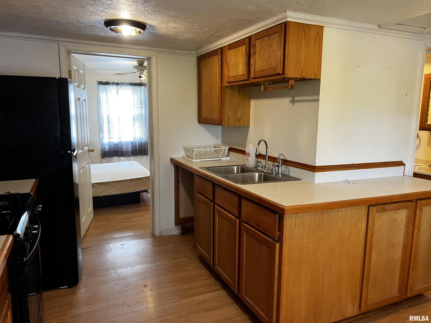 6846 East 1st Street Logan, IL 62856 - Photo 13 of 16 a bathroom with a sink a mirror and a bathtub