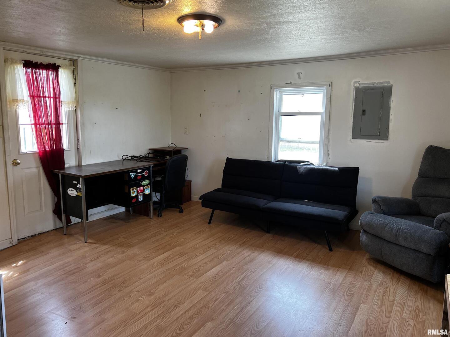 6846 East 1st Street Logan, IL 62856 - Photo 16 of 16 a living room with furniture and a wooden floor