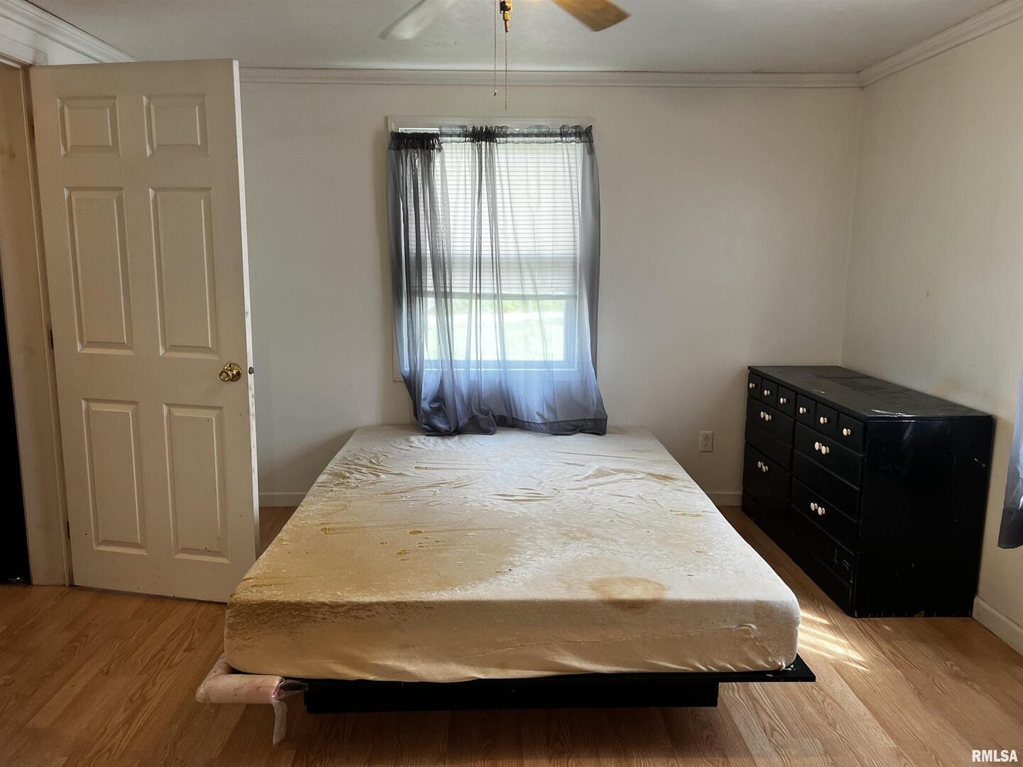 6846 East 1st Street Logan, IL 62856 - Photo 9 of 16 a bedroom with a bed and window
