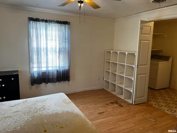 a view of an empty room with a window and closet