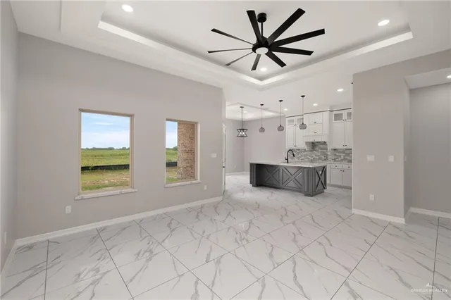 a view of a kitchen with a sink and a large window