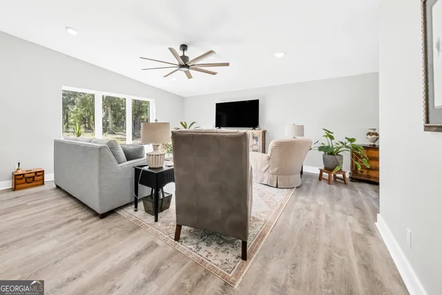a bedroom with a bed and a ceiling fan