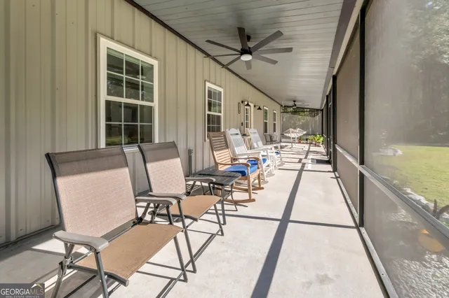 a view of a livingroom with furniture and a ceiling fan