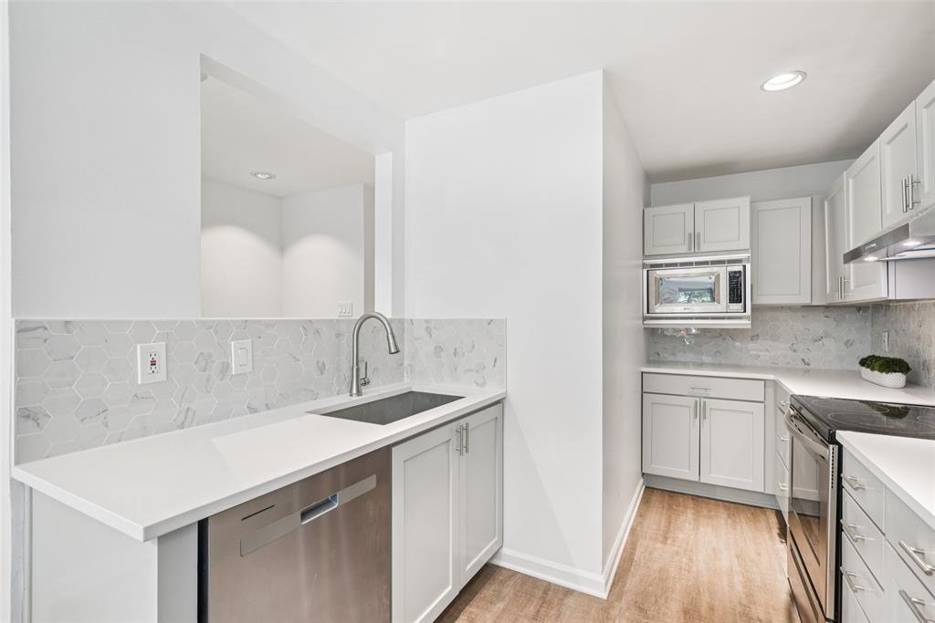 4102 Bowser Avenue, Unit 1 Dallas, TX 75219 - Photo 12 of 33 Freshly redesigned kitchen features new cabinetry, quartz surfaces, and a butcher-block peninsula perfect for casual dining