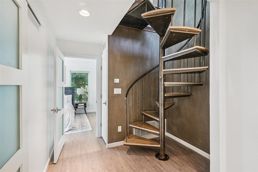 4102 Bowser Avenue, Unit 1 Dallas, TX 75219 - Photo 19 of 33 The second-floor landing features striking metal spiral stairs leading to the third level