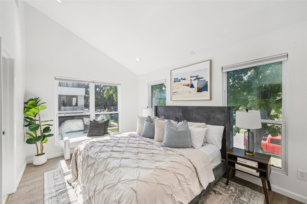 4102 Bowser Avenue, Unit 1 Dallas, TX 75219 - Photo 20 of 33 Vaulted ceiling and corner windows fill the primary suite with natural light and leafy neighborhood views
