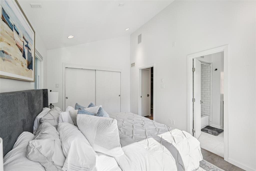 4102 Bowser Avenue, Unit 1 Dallas, TX 75219 - Photo 22 of 33 Soaring ceilings and a generous layout enhance the bright, airy feel of the primary bedroom.