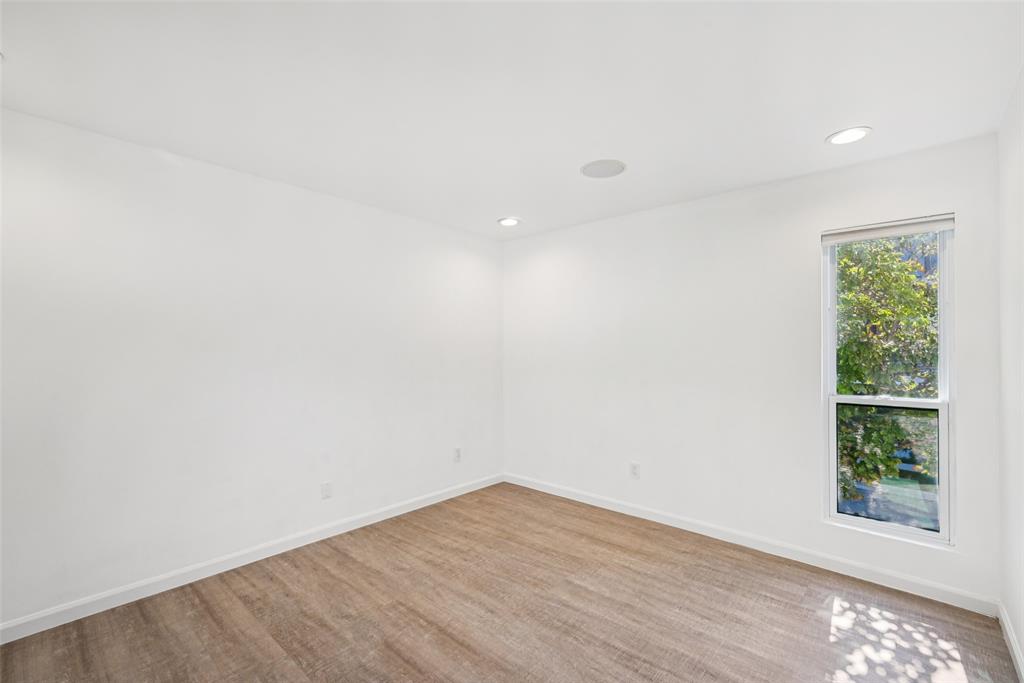 4102 Bowser Avenue, Unit 1 Dallas, TX 75219 - Photo 25 of 33 Spacious corner bedroom with wide plank flooring and treetop outlooks