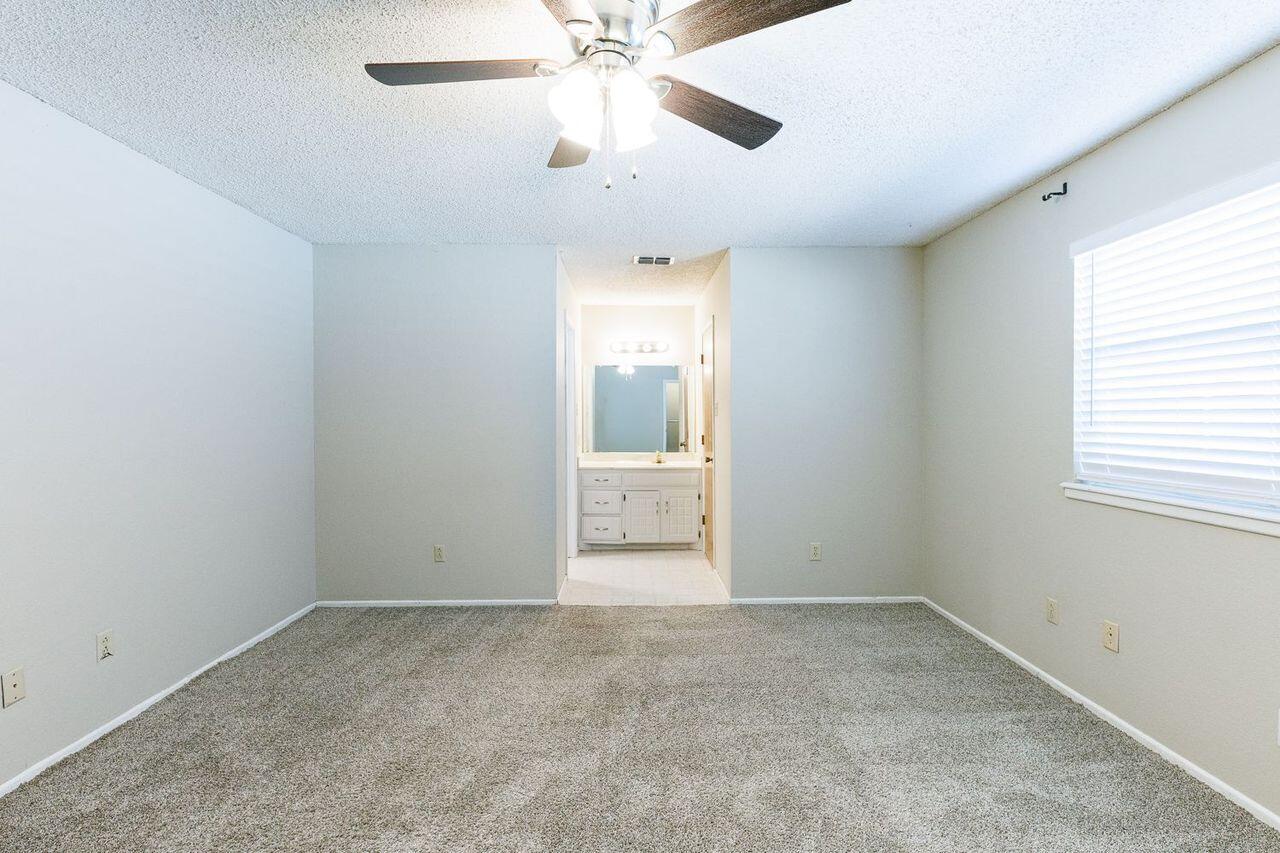 3409 84th Street Lubbock, TX 79423 - Photo 14 of 25 a view of an empty room with a window
