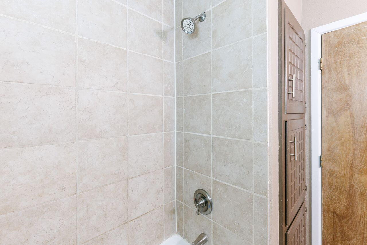 3409 84th Street Lubbock, TX 79423 - Photo 16 of 25 a bathroom with a shower
