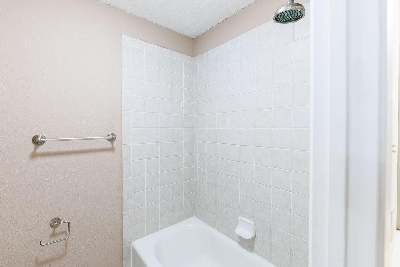3409 84th Street Lubbock, TX 79423 - Photo 20 of 25 a bathroom with a shower and toilet