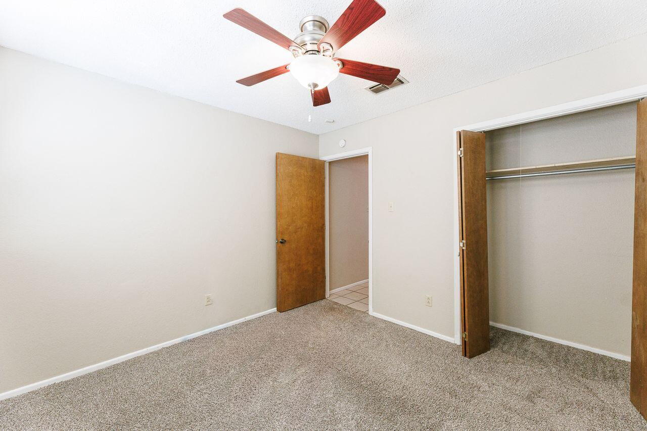 3409 84th Street Lubbock, TX 79423 - Photo 22 of 25 an empty room with closet and a ceiling fan