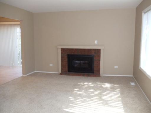 1732 Raintree Court, Unit 1732 Sycamore, IL 60178 - Photo 3 of 10 a view of empty room with a fireplace