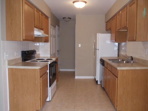 1732 Raintree Court, Unit 1732 Sycamore, IL 60178 - Photo 4 of 10 a kitchen with a sink a stove and a refrigerator