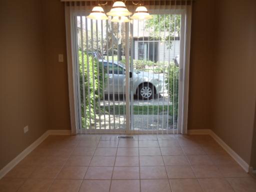1732 Raintree Court, Unit 1732 Sycamore, IL 60178 - Photo 6 of 10 a room with a large window and outdoor space