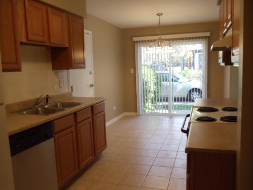 1732 Raintree Court, Unit 1732 Sycamore, IL 60178 - Photo 7 of 10 a kitchen with a sink a stove and a wooden cabinets