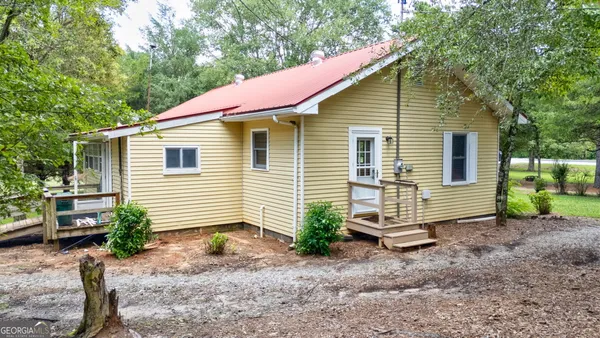 a view of a house with a yard and plants