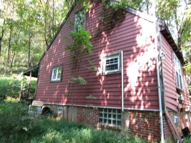 a view of a brick wall with a small yard