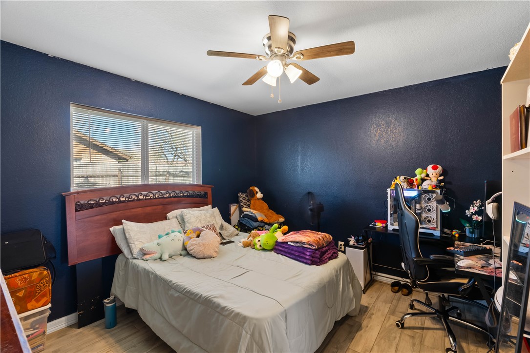 985 Ribbontail Street Corpus Christi, TX 78418 - Photo 11 of 15 a bedroom with a bed and a window