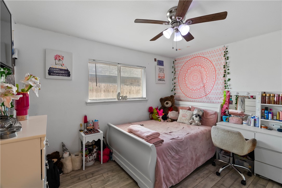 985 Ribbontail Street Corpus Christi, TX 78418 - Photo 12 of 15 a bed room with a bed mirror and a chandelier