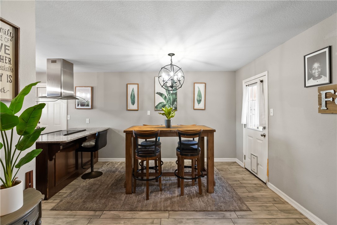 985 Ribbontail Street Corpus Christi, TX 78418 - Photo 7 of 15 a view of a dining room with furniture window and wooden floor