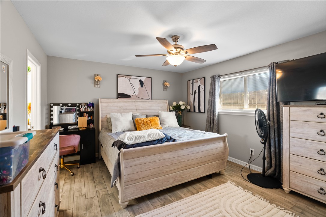 985 Ribbontail Street Corpus Christi, TX 78418 - Photo 9 of 15 a bedroom with a bed and a flat tv screen on dresser