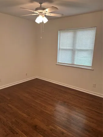 a view of a room with wooden floor closet and chandelier fan