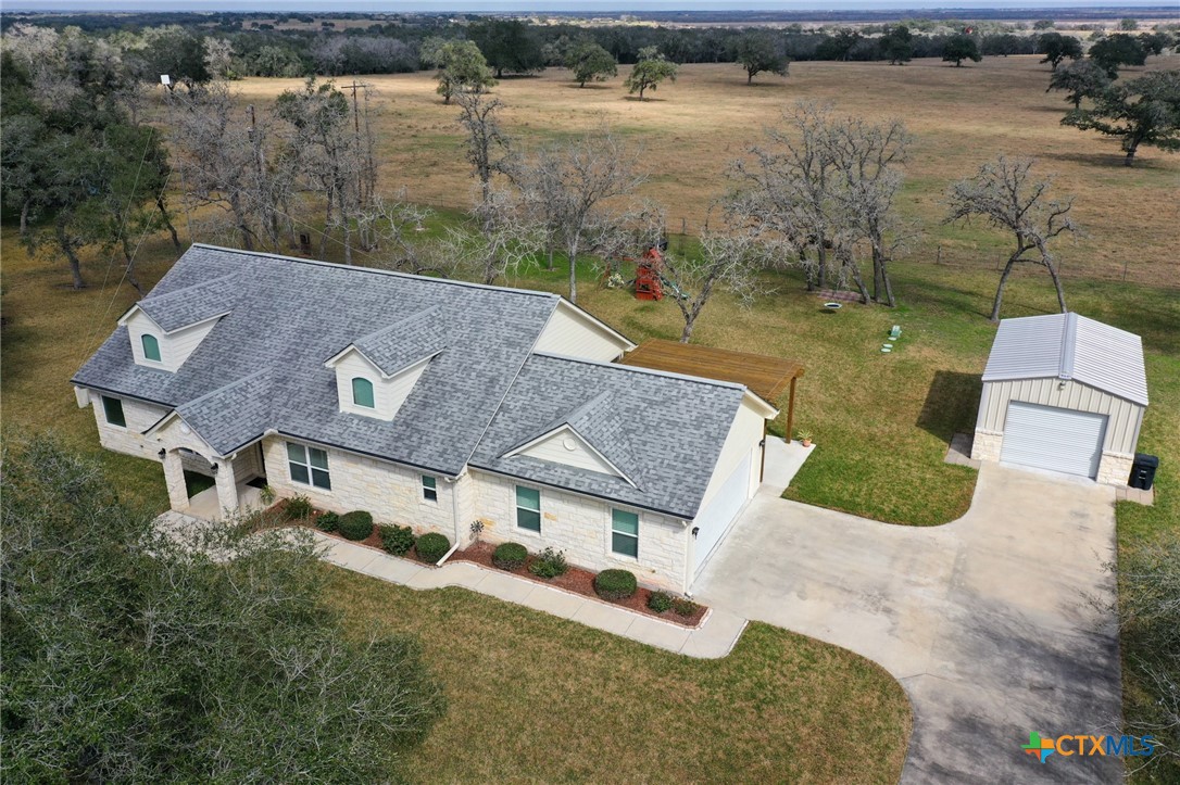 an aerial view of a house with outdoor space and lake view