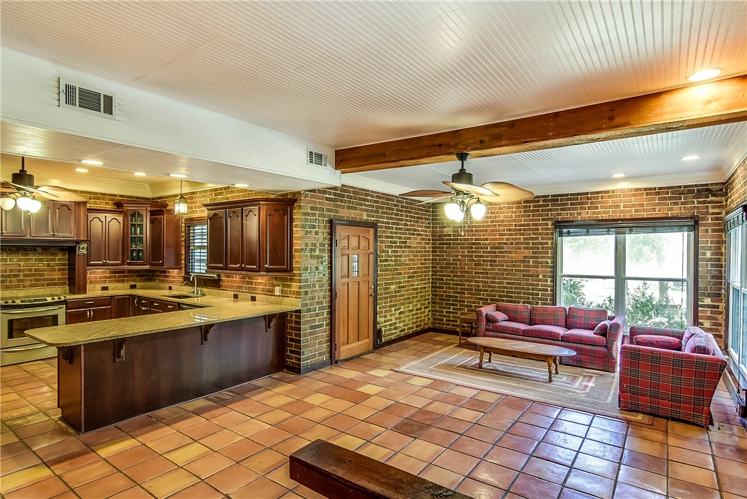 97668 Pirates Point Road Yulee, FL 32097 - Photo 8 of 29 a kitchen with a stove kitchen island dining table and chairs