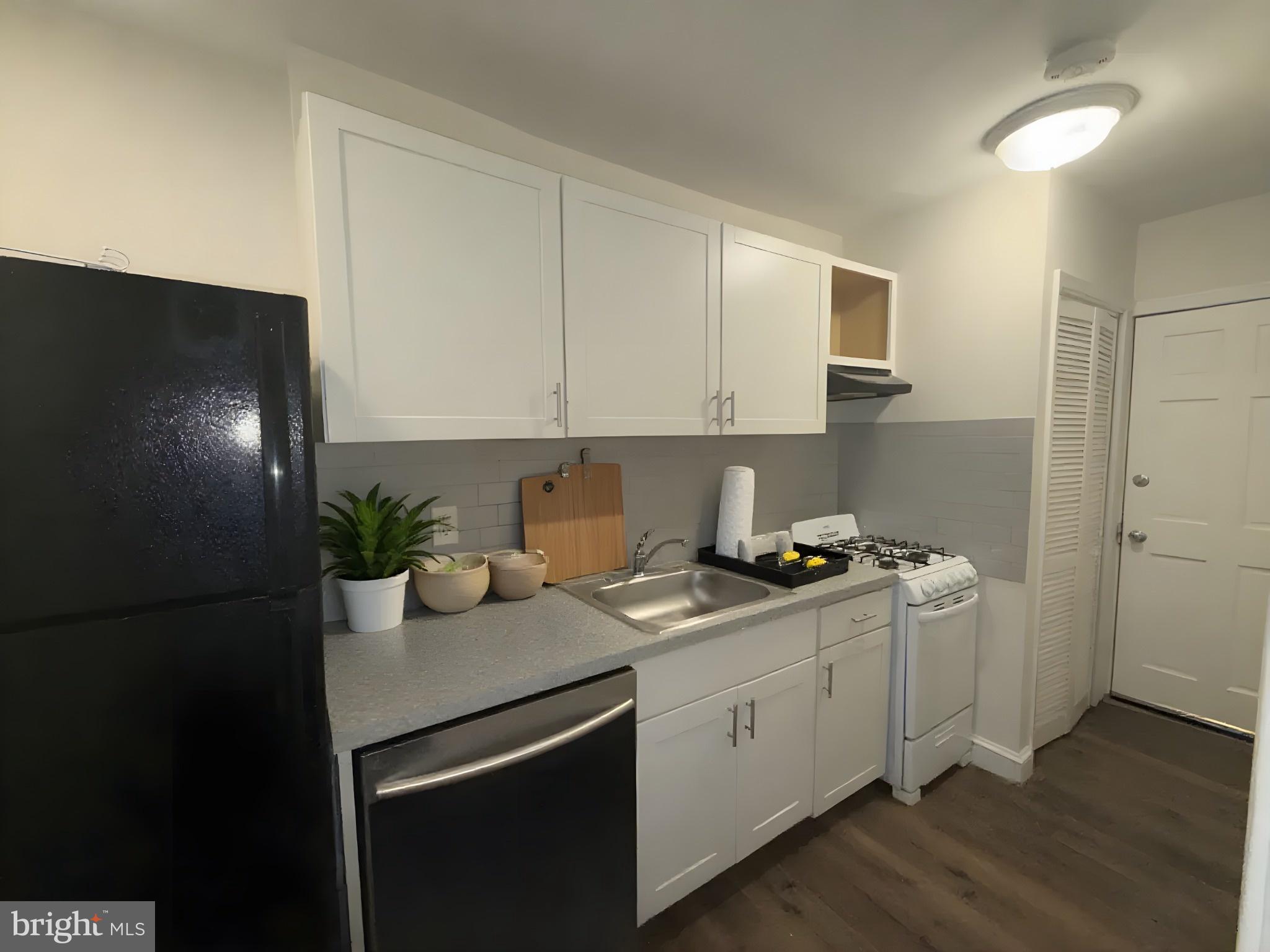 102 O Street Southwest, Unit 1 Washington, DC 20024 - Photo 6 of 10 a kitchen with stainless steel appliances granite countertop a sink stove and refrigerator