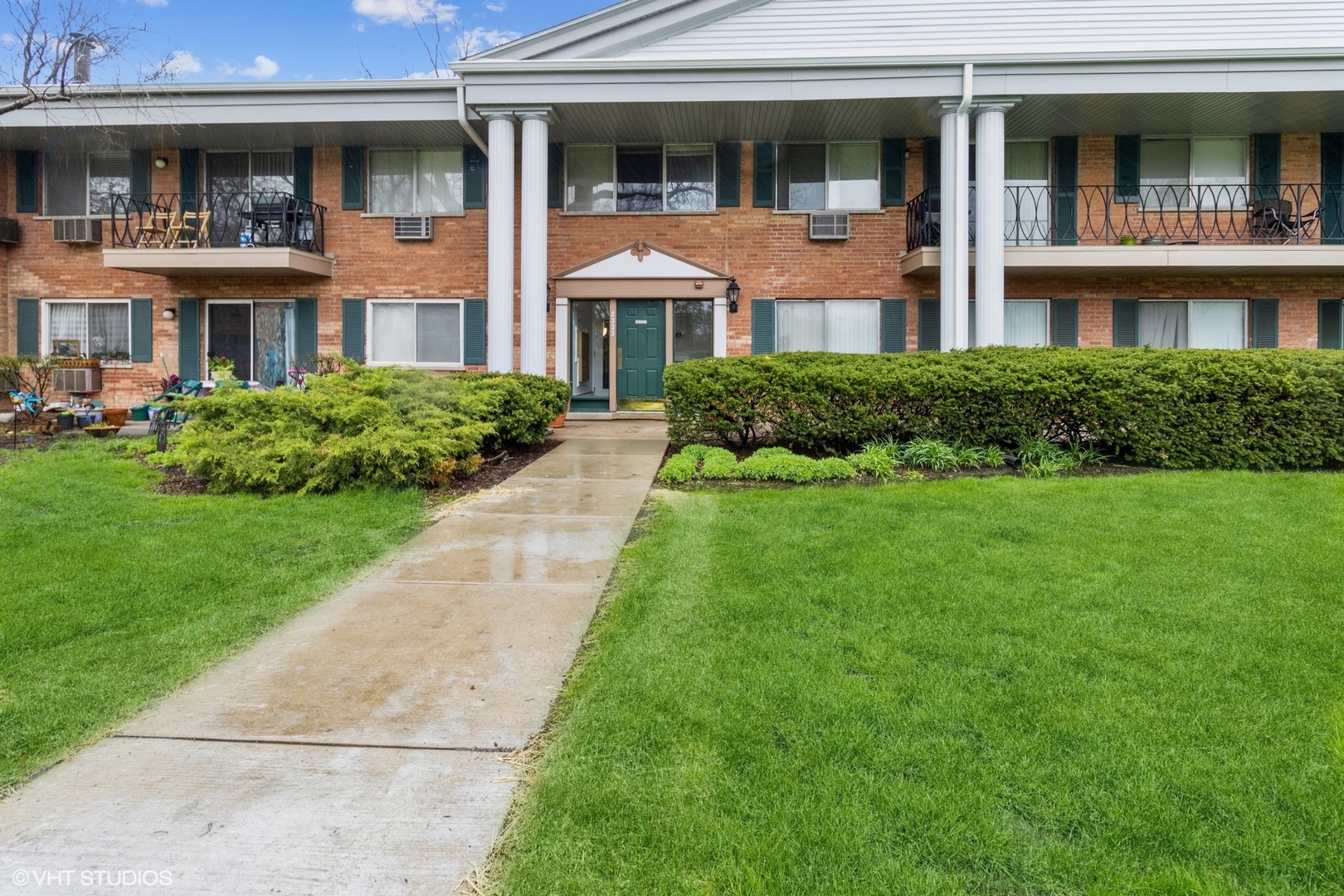 2323 South Goebbert Road, Unit 109 Arlington Heights, IL 60005 - Photo 1 of 11 a front view of a residential apartment building with a yard