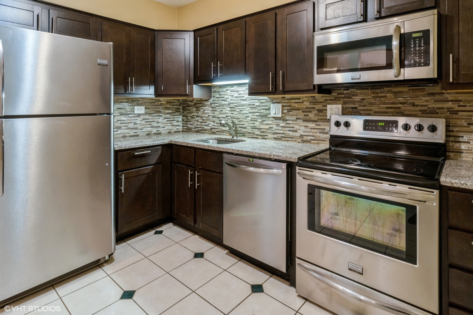 2323 South Goebbert Road, Unit 109 Arlington Heights, IL 60005 - Photo 2 of 11 a kitchen with appliances a refrigerator and cabinets