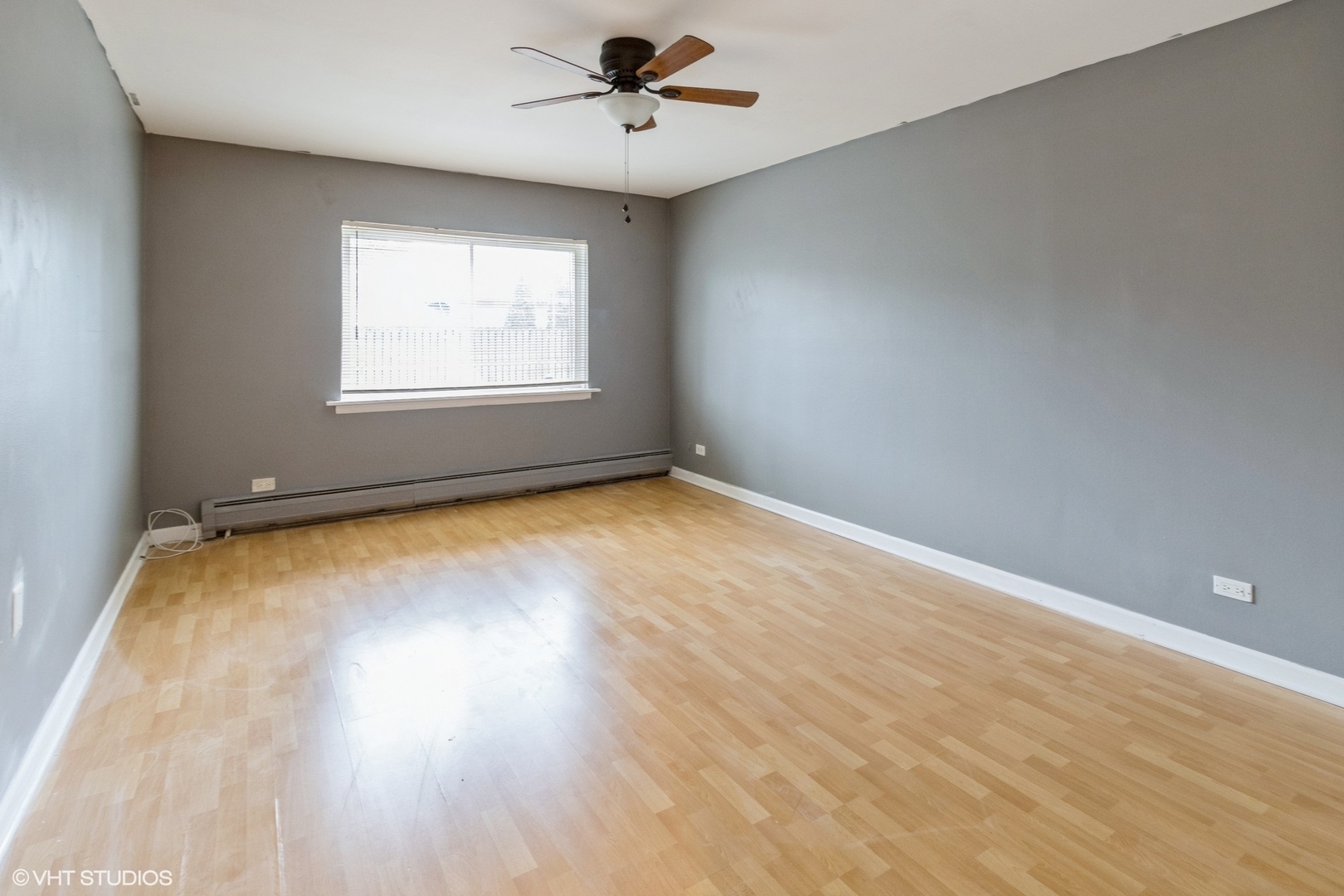 2323 South Goebbert Road, Unit 109 Arlington Heights, IL 60005 - Photo 5 of 11 wooden floor in an empty room with a window
