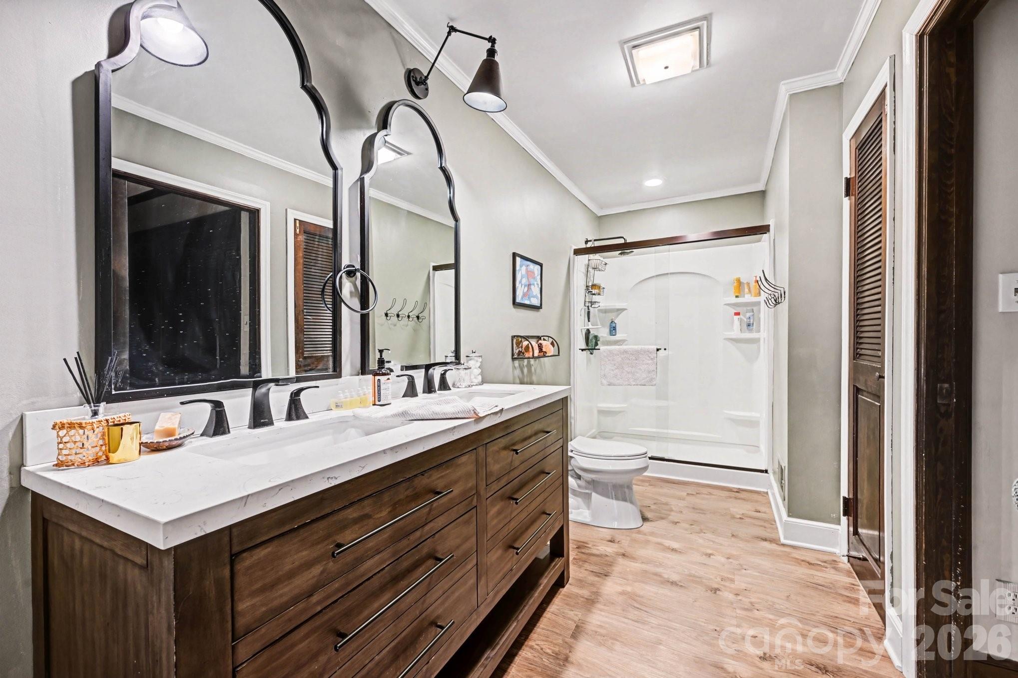 2915 Old Stage Road Gastonia, NC 28052 - Photo 13 of 42 a spacious bathroom with a double vanity sink toilet mirror and bathtub