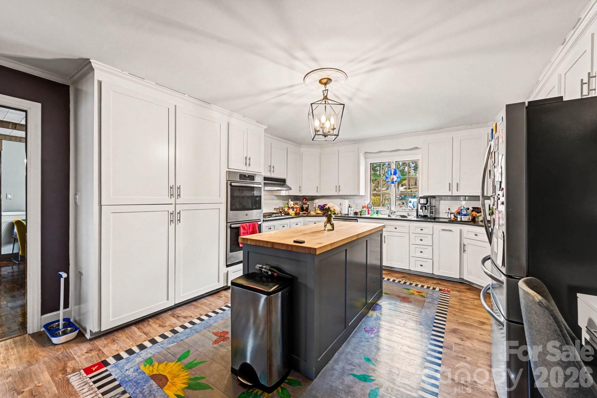 2915 Old Stage Road Gastonia, NC 28052 - Photo 21 of 42 a kitchen with kitchen island stainless steel appliances a stove refrigerator sink and cabinets