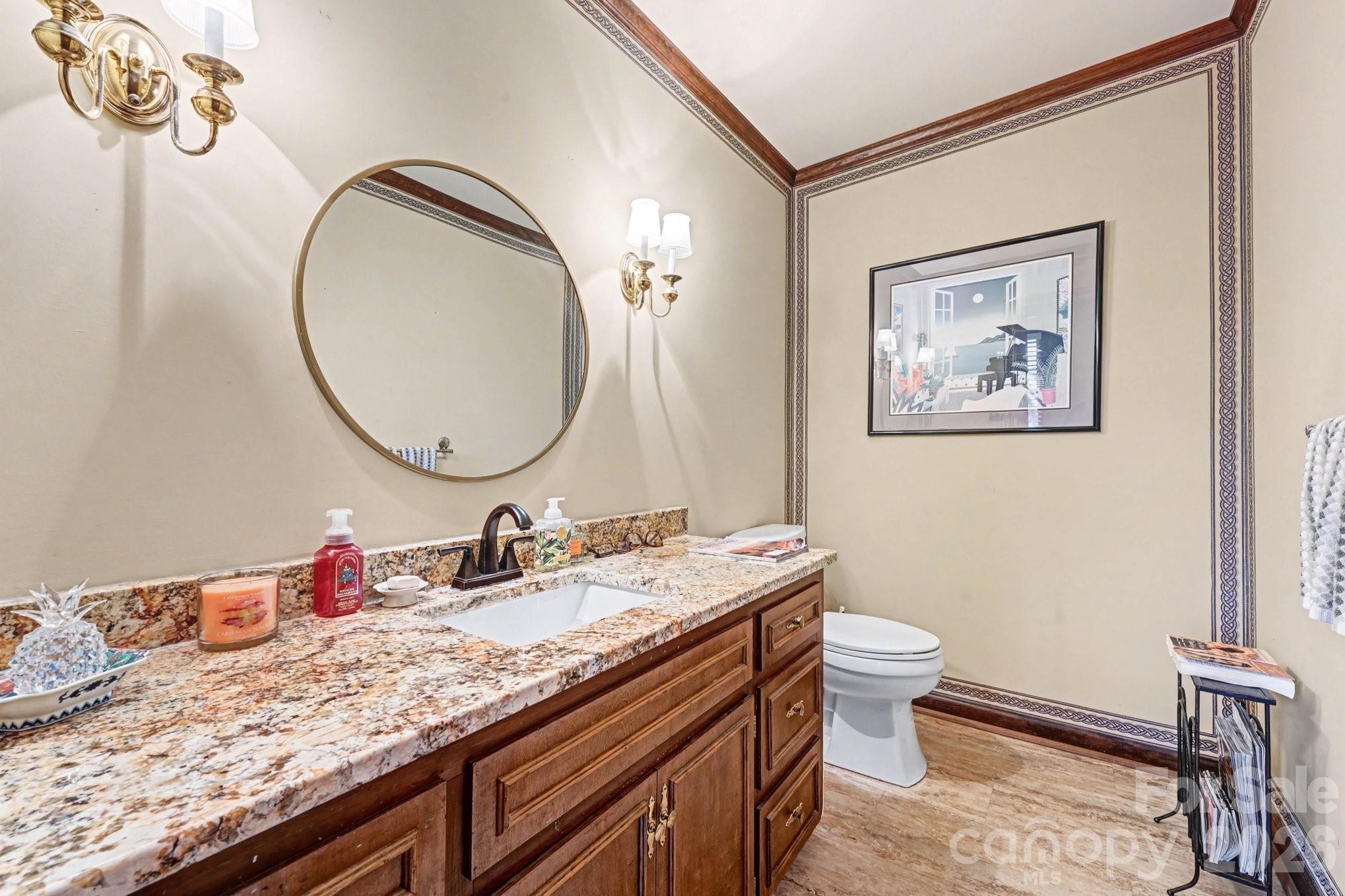 2915 Old Stage Road Gastonia, NC 28052 - Photo 24 of 42 a bathroom with a granite countertop toilet a sink and a mirror
