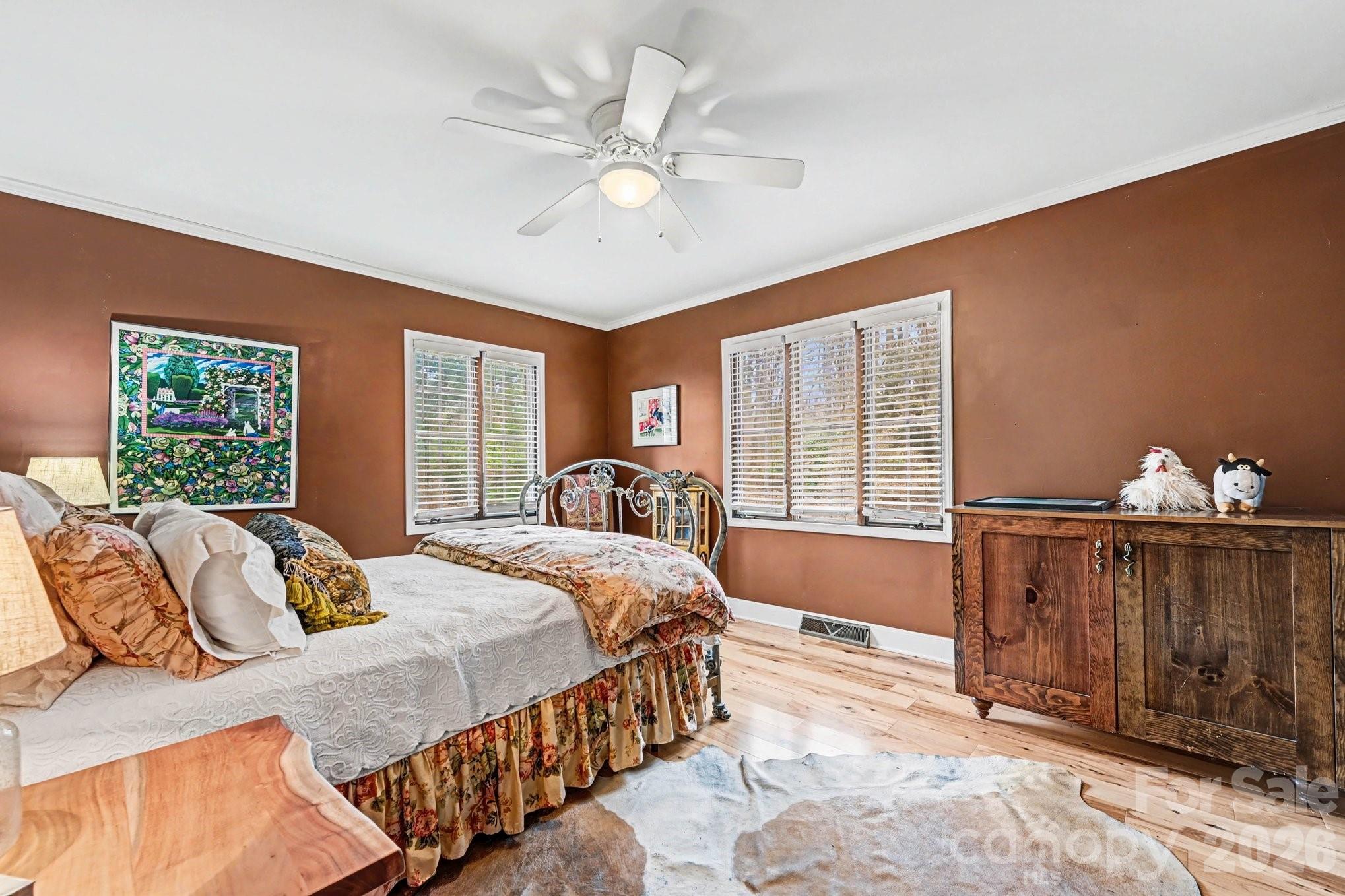 2915 Old Stage Road Gastonia, NC 28052 - Photo 7 of 42 a bedroom with a large bed and a chandelier